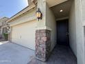 Inviting front entrance with stone accents and a secure screen door, enhancing both style and security at 3717 E Lodgepole Dr, Gilbert, AZ 85298