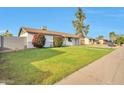 Well-maintained single-story home with a spacious front yard and a mature tree in a quiet neighborhood at 3718 W Columbine Dr, Phoenix, AZ 85029