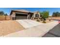 Inviting single-level home featuring desert landscaping, a spacious driveway, and a charming front entrance at 41290 W Ganley Way, Maricopa, AZ 85138
