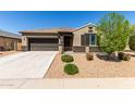 Beautiful single-Gathering home with desert landscaping, a two-car garage, and a well-maintained lawn at 41290 W Ganley Way, Maricopa, AZ 85138