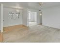 Bright living room featuring neutral carpeting and a glimpse into adjacent rooms at 5038 E Morning Star Dr, Phoenix, AZ 85044