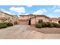 Charming home featuring a well-manicured lawn, a two-car garage and a driveway in a residential area at 6818 W St Catherine Ave, Laveen, AZ 85339
