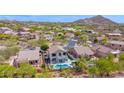 Stunning aerial view of a neighborhood with lush landscaping and mountain views at 7242 E Tyndall St, Mesa, AZ 85207