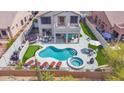 Aerial view of a private backyard retreat featuring a pool, spa, patio, and lush greenery at 7242 E Tyndall St, Mesa, AZ 85207