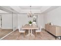 Formal dining room featuring chandelier, sideboard, and neutral finishes at 7250 E Paradise Dr, Scottsdale, AZ 85260
