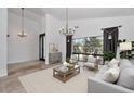 Bright living room with tile flooring, elegant chandelier and neutral decor at 7250 E Paradise Dr, Scottsdale, AZ 85260
