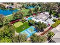 Aerial view showing a private tennis court and putting green with outdoor seating and red floral landscaping at 87 Biltmore Est, Phoenix, AZ 85016
