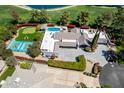 Beautiful aerial view showcasing a private tennis court and putting green next to a luxury home in Scottsdale, AZ at 87 Biltmore Est, Phoenix, AZ 85016