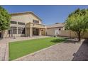 Spacious backyard with artificial turf, gravel accents, and covered patio area at 927 W Azalea Pl, Chandler, AZ 85248