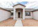 A covered front entryway highlights a simple exterior with a brown door and matching shutters at 9430 W Sandstone Mountain Dr, Casa Grande, AZ 85194