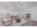 Open-concept living room featuring neutral decor, wood-look flooring, and lots of natural light at 9430 W Sandstone Mountain Dr, Casa Grande, AZ 85194
