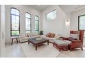 Bright living room with high ceilings, oversized windows, and comfortable seating at 10843 E Acacia Dr, Scottsdale, AZ 85255