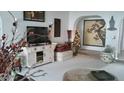 Cozy living room featuring an entertainment center, seasonal decor, and an arched entryway at 1222 E Acoma Dr, Phoenix, AZ 85022