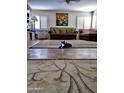 Spacious living room with parquet floors, a neutral sofa, and large area rug at 1222 E Acoma Dr, Phoenix, AZ 85022