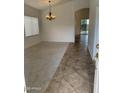 Spacious living room featuring neutral carpet, modern lighting fixture, and seamless flow to other areas at 8659 E Mescal St, Scottsdale, AZ 85260