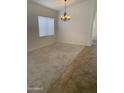 Living room features neutral carpet, modern lighting fixture, and bright window at 8659 E Mescal St, Scottsdale, AZ 85260