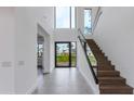 Grand foyer features a floating staircase, high ceilings, and a clear view of the exterior at 100 W Northern Ave # 15, Phoenix, AZ 85021