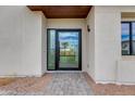 Close-up of front door with stone pathway showcasing the modern design and inviting entrance at 100 W Northern Ave # 15, Phoenix, AZ 85021