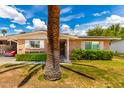 Charming brick home with manicured lawn and desert landscaping under a sunny sky at 10418 W Corte Del Sol Oeste --, Sun City, AZ 85351