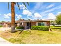 Charming brick home with manicured lawn and desert landscaping under a sunny sky at 10418 W Corte Del Sol Oeste --, Sun City, AZ 85351