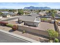 An aerial shot of a fenced in backyard and desert landscaping with mountain views at 1057 W Mesquite Ave, Apache Junction, AZ 85120