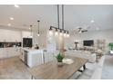 Open-concept dining area with modern lighting fixtures, adjacent to kitchen and living spaces at 10907 W Woodruff Rd, Casa Grande, AZ 85194