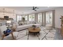 Open-concept living area with bright windows, modern decor, and seamless access to the kitchen at 10981 W Woodruff Rd, Casa Grande, AZ 85194