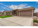 Charming home featuring manicured landscaping, a three-car garage, and a welcoming entryway at 11055 E Ocaso Ave, Mesa, AZ 85212