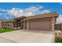 Charming home featuring manicured landscaping, a three-car garage, and a welcoming entryway at 11055 E Ocaso Ave, Mesa, AZ 85212