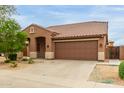 Attractive single-story house with a large driveway and classic tile roof at 11277 W Buchanan St, Avondale, AZ 85323