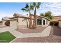 Single-story home with desert landscaping, a two car garage, and front bay window provides attractive curb appeal at 116 W Jasper Dr, Gilbert, AZ 85233
