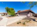Charming home featuring a two-car garage, well-kept lawn, and desert landscaping at 12415 N 41St Dr, Phoenix, AZ 85029