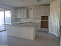 Modern kitchen with white cabinets, gray granite countertops, an island, and stainless steel appliances at 13250 W Eagle Feather Rd, Peoria, AZ 85383