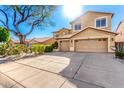 Inviting two-story home with a two-car garage, desert landscaping, and a spacious driveway at 1344 N Constellation Way, Gilbert, AZ 85234
