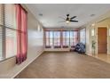 Versatile room with wood-look floors, ceiling fan, and ample natural light, ideal for an exercise room at 1391 E Angie St, Casa Grande, AZ 85122