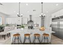 Spacious kitchen featuring a large island with seating, stainless steel appliances, and open layout at 13947 E Barwick Dr, Scottsdale, AZ 85262
