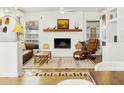 Inviting living room with a brick fireplace, exposed mantle, tiled floors and large windows at 1508 W Kiowa Ave, Mesa, AZ 85202