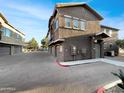 Street view of townhome units and garages within the community with desert landscaping at 15240 N 142Nd Ave # 2102, Surprise, AZ 85379