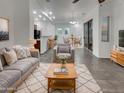 Open-concept living area with contemporary furnishings and decor, adjacent to the dining room at 15240 N 142Nd Ave # 2102, Surprise, AZ 85379