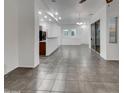 Open-concept living area with tile flooring, neutral paint, and access to the dining area at 15240 N 142Nd Ave # 2102, Surprise, AZ 85379
