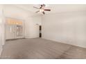 Bright living room with neutral carpet, a ceiling fan, and natural light from a doorway and entry way at 1716 N Temple St, Mesa, AZ 85203