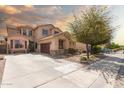 Inviting residence featuring a long driveway and desert landscaping offering great curb appeal and neighborhood charm at 21557 N Anne Ln, Maricopa, AZ 85138