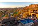 Beautiful pool and outdoor patio with golf course and mountain views, perfect for entertaining guests at 26796 N 98Th Way, Scottsdale, AZ 85262