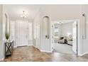 Bright foyer with tile flooring, offers a view into a cozy room with comfortable seating and neutral tones at 27420 N 170Th St, Rio Verde, AZ 85263