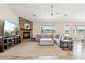 Spacious living room features a stone fireplace, large sectional sofa, and expansive windows offering desert views at 27420 N 170Th St, Rio Verde, AZ 85263