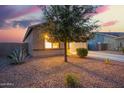 Well-maintained single-story home with a two-car garage and desert landscaping at dusk at 30370 N Opal Dr, San Tan Valley, AZ 85143