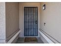 Close-up of the home's front door with security screen and covered entryway at 3327 W Mohawk Ln, Phoenix, AZ 85027