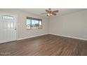 Bright living room featuring laminate flooring and a large front window at 352 E Beatryce St, Tempe, AZ 85288