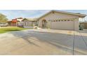 Neutral-colored single Gathering home with well-manicured turf and an attached two-car garage at 3907 W Sharon Ave, Phoenix, AZ 85029