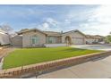 A single story home with well maintained turf and a neutral color scheme in a suburban neighborhood at 3907 W Sharon Ave, Phoenix, AZ 85029